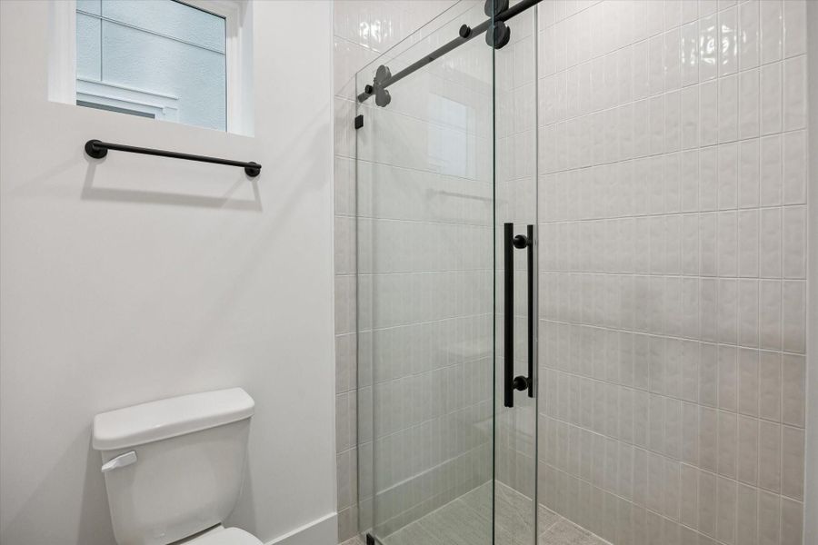 Stylish secondary bath with optional *upgrade walk-in shower upgrade, offering a clean and contemporary design.