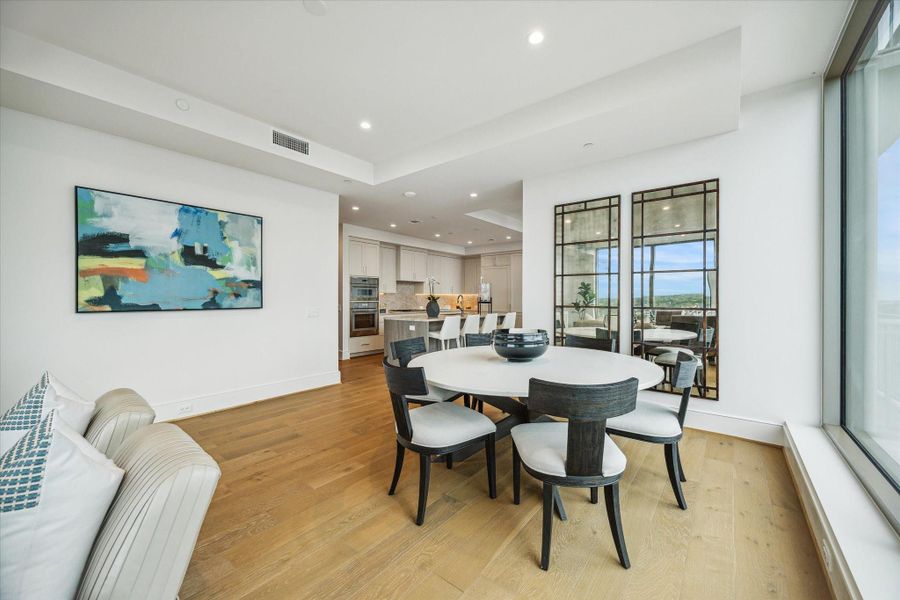 Spacious dining area features an open-concept layout seamlessly connected to the kitchen and living spaces. Spacious dining area features an open-concept layout seamlessly connected to the kitchen and living spaces.