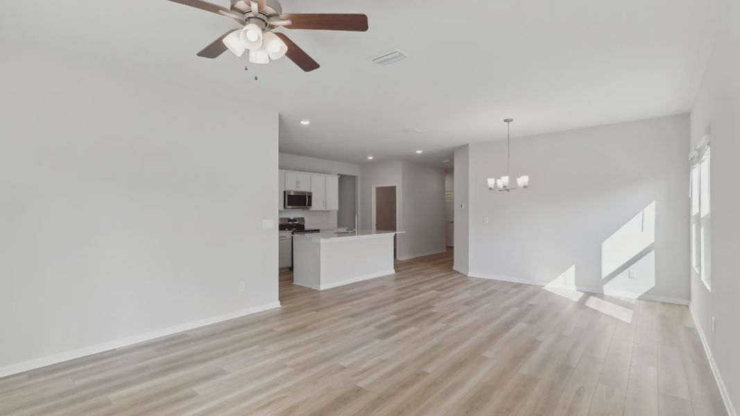 Elegant hardwood floors enhance the open-concept living area in this Palm Coast residence.