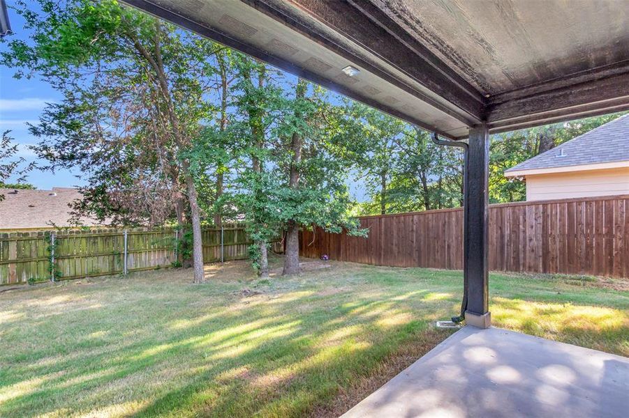 Fenced backyard with a patio
