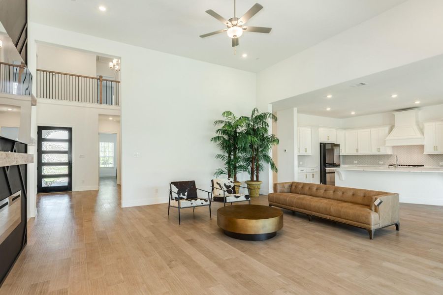 From the foyer, you are greeted by an expansive family living area that showcases an inviting open-concept design. This thoughtful layout creates a seamless flow, effortlessly connecting the family room, kitchen, and dining space to provide an ideal environment for both daily living and entertaining.