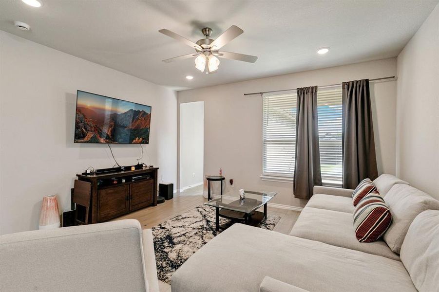 Living room featuring light hardwood / wood-style flooring and ceiling fan