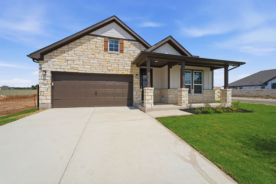 Front exterior of a new home in Santa Rita Ranch, Liberty Hill, TX, highlighting curb appeal (Image 27).