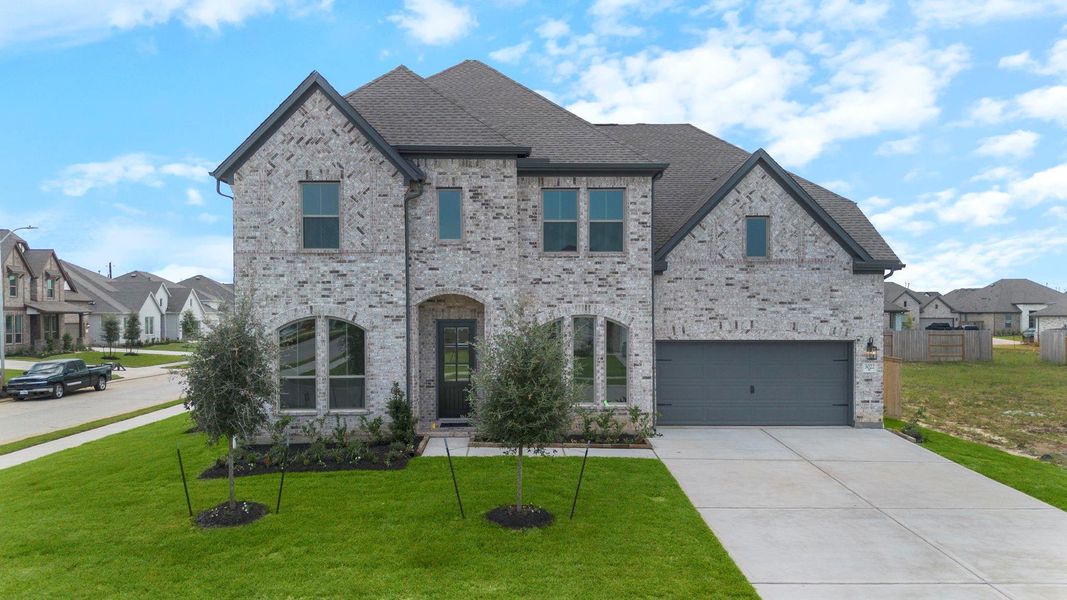 Front exterior of a new home in Coastal Point, League City, TX, highlighting curb appeal (Image 19). Front exterior of a new home in Coastal Point, League City, TX, highlighting curb appeal (Image 19).