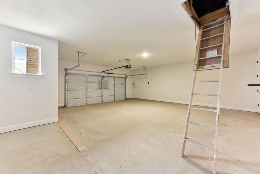 Garage featuring baseboards