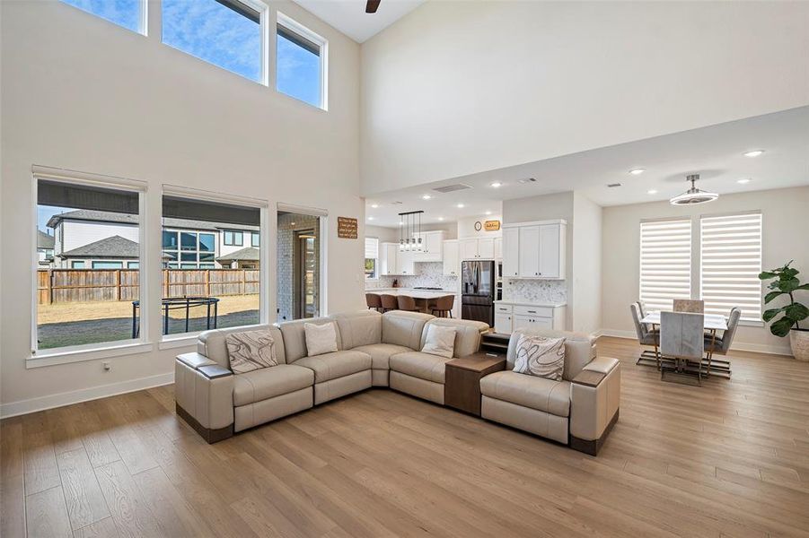 Look at all of the light in the two-story family room, which opens to the kitchen and dining room