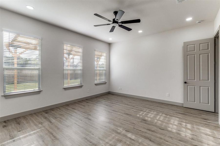 Spare room with recessed lighting, light wood-style flooring, and a ceiling fan Spare room with recessed lighting, light wood-style flooring, and a ceiling fan