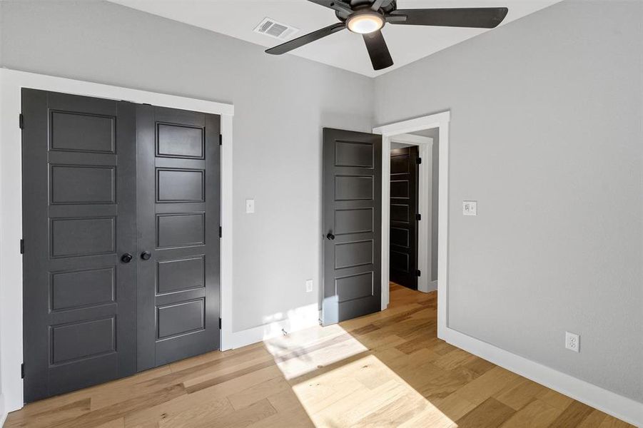 Unfurnished bedroom featuring a closet, light wood finished floors, and a ceiling fan Unfurnished bedroom featuring a closet, light wood finished floors, and a ceiling fan
