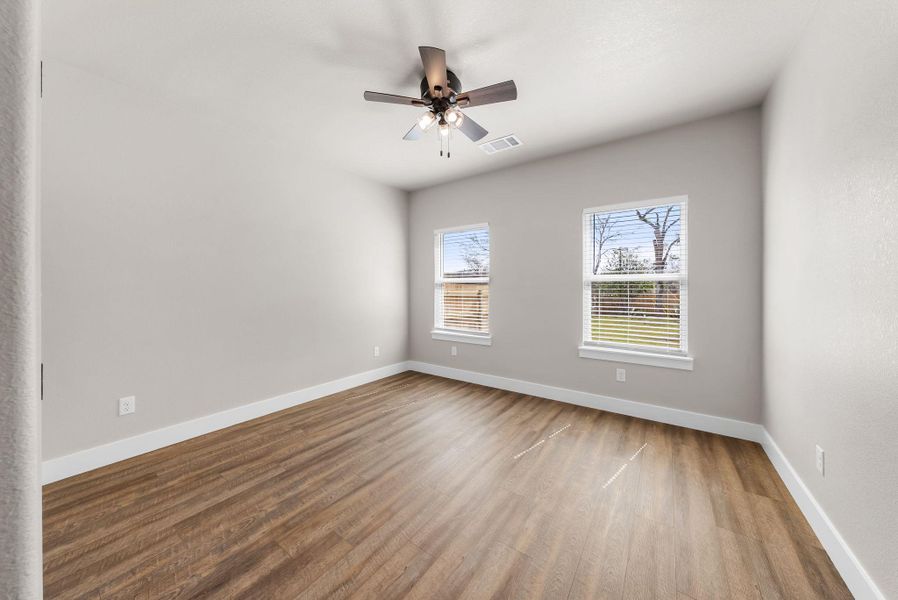 Empty room with ceiling fan and wood finished floors