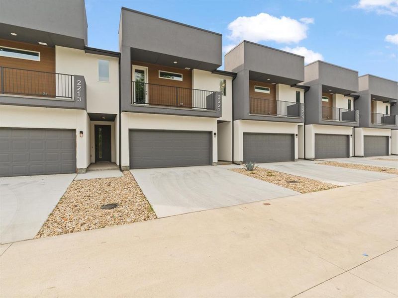 View of front facade with a garage, stucco siding, and driveway View of front facade with a garage, stucco siding, and driveway