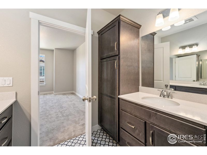 Second vanity in primary bedroom w/ built in linen cabinet