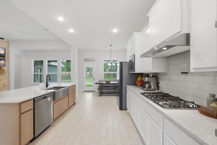 Bright, open kitchen with ample counter space, modern finishes, and a seamless flow.