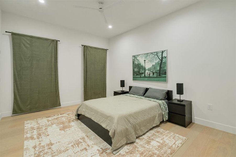 Bedroom with light wood-style floors, ceiling fan, and recessed lighting Bedroom with light wood-style floors, ceiling fan, and recessed lighting