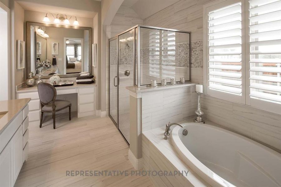 Full bath featuring vanity, a stall shower, and a bath Full bath featuring vanity, a stall shower, and a bath