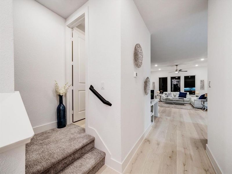 Hall with light wood finished floors and recessed lighting Hall with light wood finished floors and recessed lighting