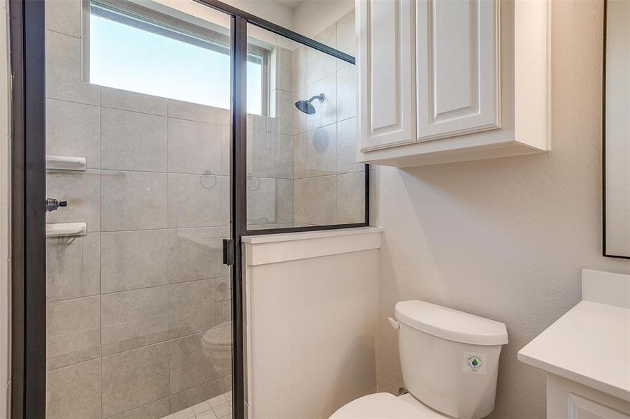 Bathroom with vanity, toilet, and an enclosed shower