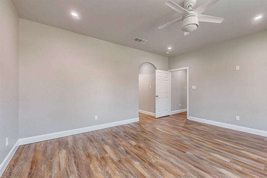 Empty room with ceiling fan and hardwood / wood-style floors