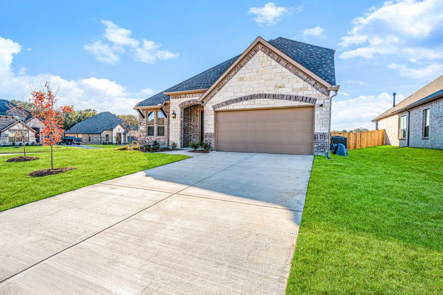 Front exterior of a new home in Forest Ridge Estates, Greenville, TX, highlighting curb appeal (Image 22).