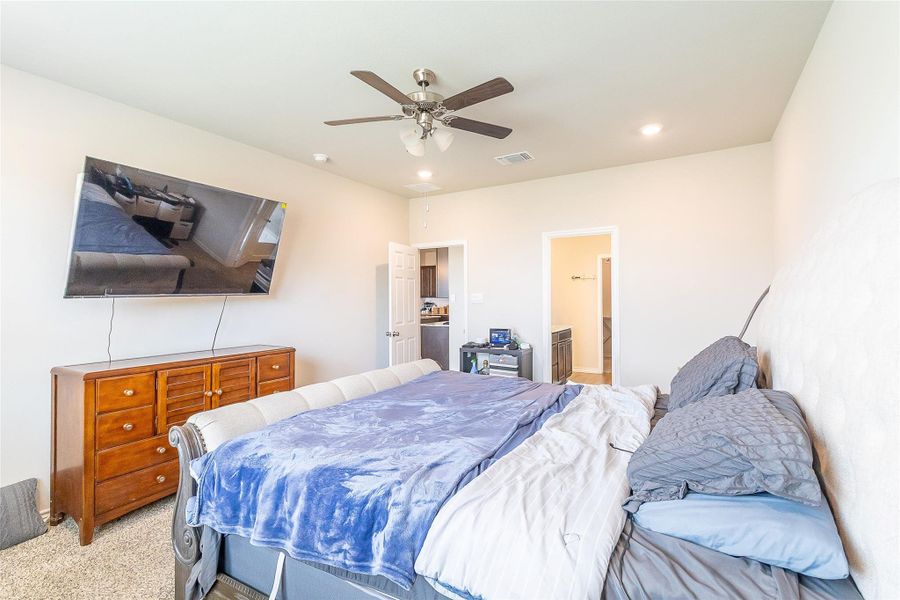 Well-lit sleeping quarters with plush carpeting and a convenient open doorway.