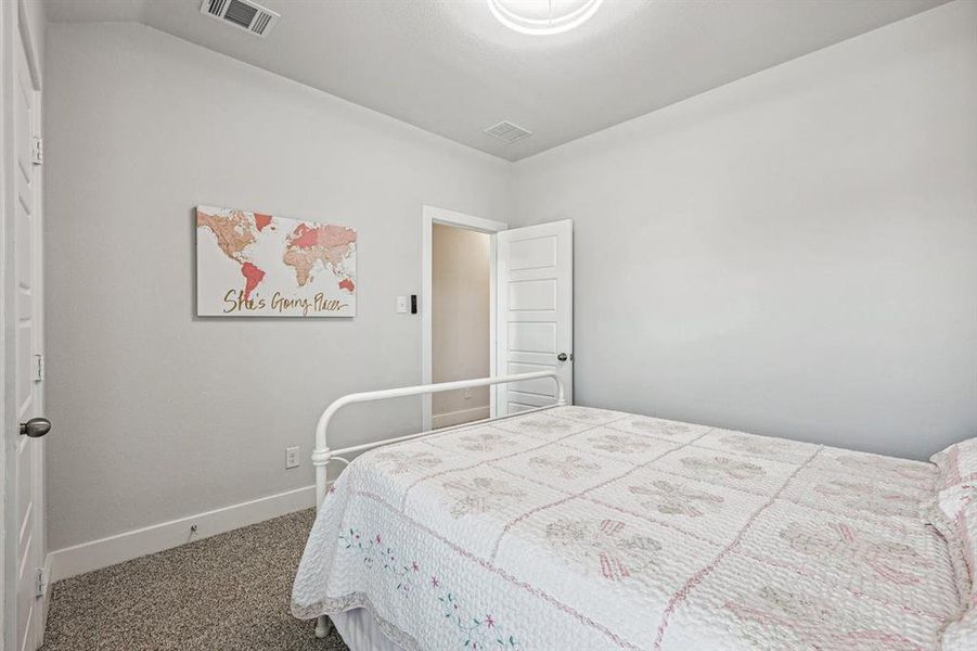 View of carpeted bedroom and fandalier