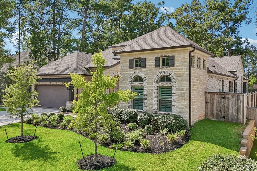 Front exterior of a new home in The Woodlands Hills, Willis, TX, highlighting curb appeal (Image 21).