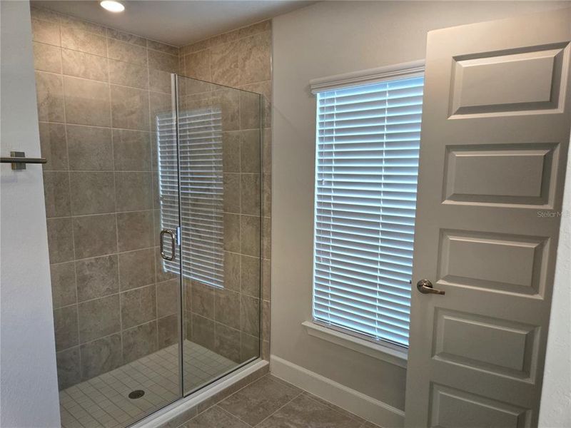 tiled shower and linen closet