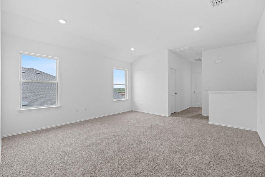Spare room with light colored carpet, recessed lighting, and lofted ceiling Spare room with light colored carpet, recessed lighting, and lofted ceiling