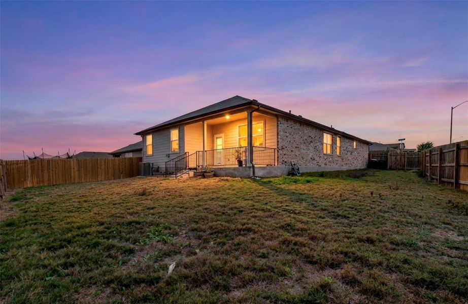 Rear view of property featuring a fenced backyard and covered porch Rear view of property featuring a fenced backyard and covered porch