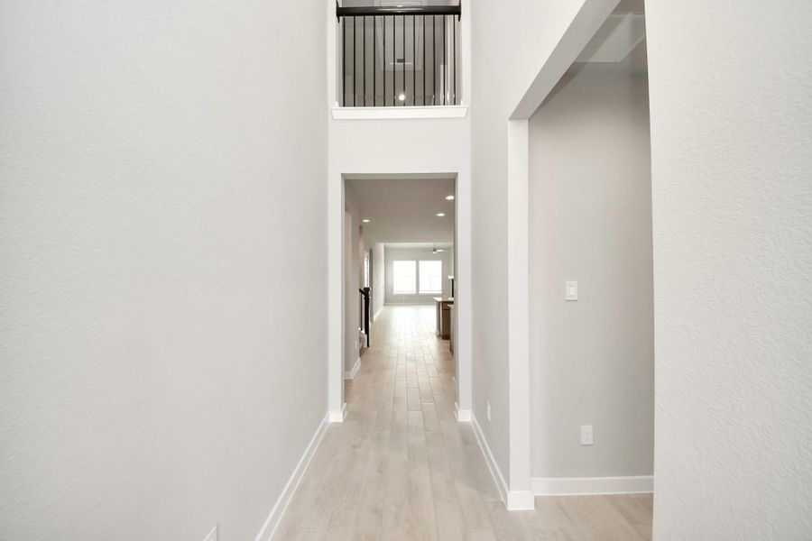 As you step into the threshold of this luxurious home, you'll soon be welcomed by an elegant glass door (to be installed). Inside, soaring ceilings amplify the spaciousness, while the refined wood-look tile flooring and oversized baseboards exude sophistication and charm. Sample photo of completed home with similar floor plan. Actual colors and selections may vary. As you step into the threshold of this luxurious home, you'll soon be welcomed by an elegant glass door (to be installed). Inside, soaring ceilings amplify the spaciousness, while the refined wood-look tile flooring and oversized baseboards exude sophistication and charm. Sample photo of completed home with similar floor plan. Actual colors and selections may vary.