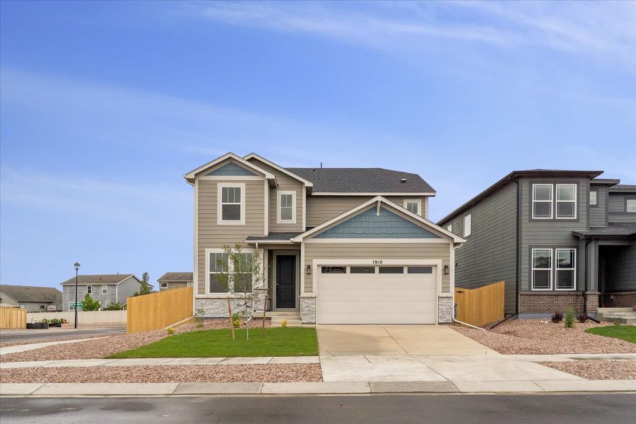 Front exterior of a new home in Aspen Meadows-4, Colorado Springs, CO, highlighting curb appeal (Image 2).