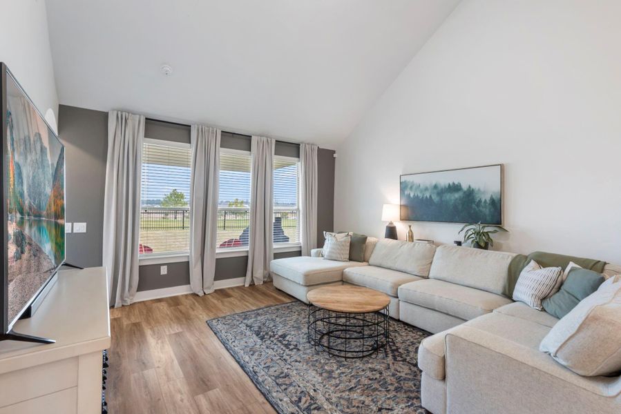 Bright and inviting living room with high ceilings, large windows, and natural light. Features a spacious sectional sofa, modern decor, and hardwood floors, creating a comfortable and stylish space. Bright and inviting living room with high ceilings, large windows, and natural light. Features a spacious sectional sofa, modern decor, and hardwood floors, creating a comfortable and stylish space.