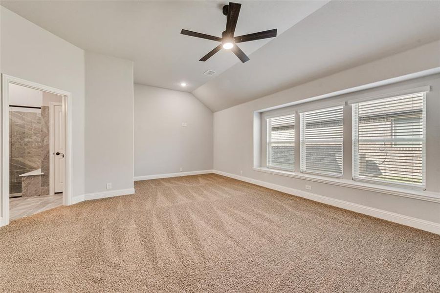 Spare room with vaulted ceiling, light colored carpet, a ceiling fan, and recessed lighting Spare room with vaulted ceiling, light colored carpet, a ceiling fan, and recessed lighting