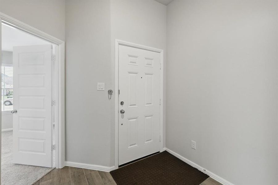 Entrance foyer with baseboards and dark wood finished floors Entrance foyer with baseboards and dark wood finished floors