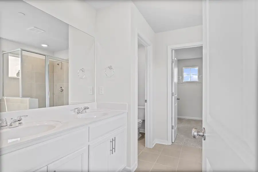 A bathroom with a sink and a mirror. A bathroom with a sink and a mirror.