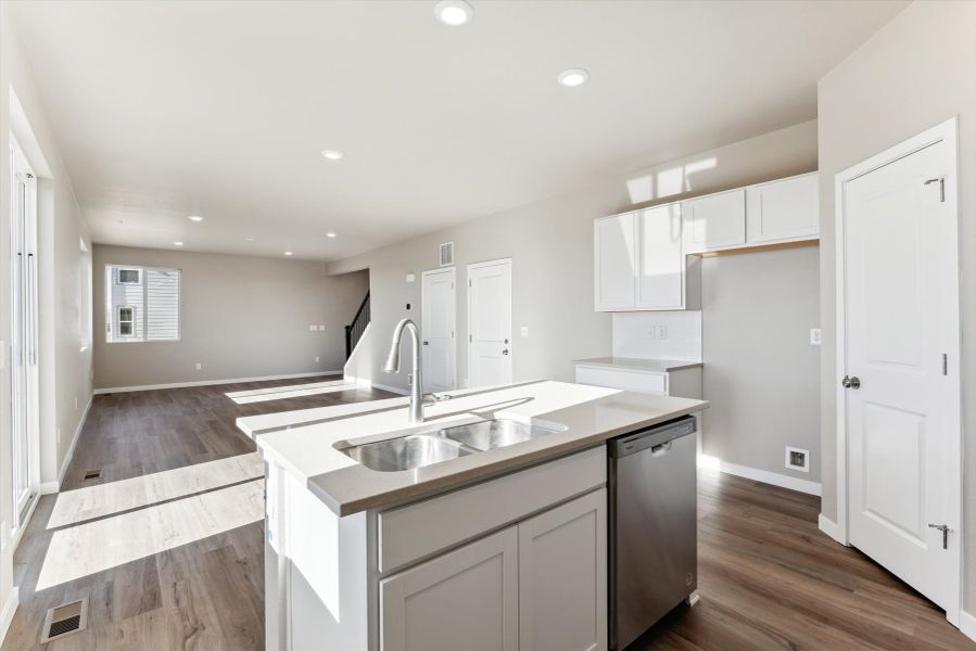 A kitchen with white cabinets.