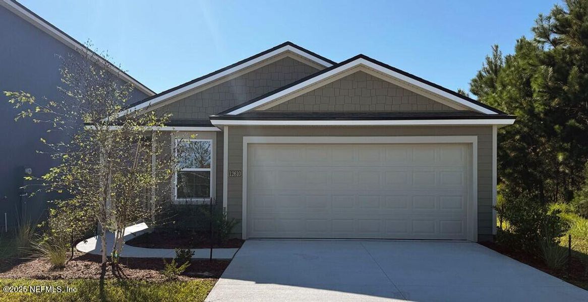 Front exterior of a new home in The Arbors, Jacksonville, FL, highlighting curb appeal (Image 26). Front exterior of a new home in The Arbors, Jacksonville, FL, highlighting curb appeal (Image 26).