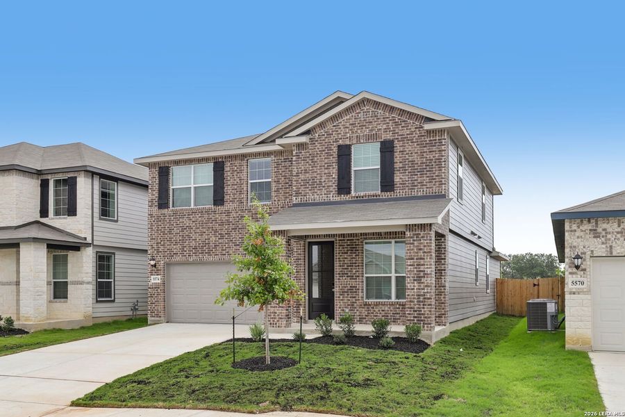 Front exterior of a new home in Thomas Pond, San Antonio, TX, highlighting curb appeal (Image 23).