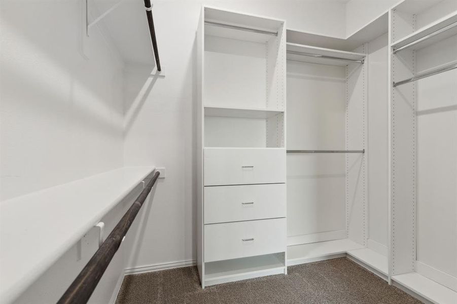 Primary bedroom custom designed walk in closet.