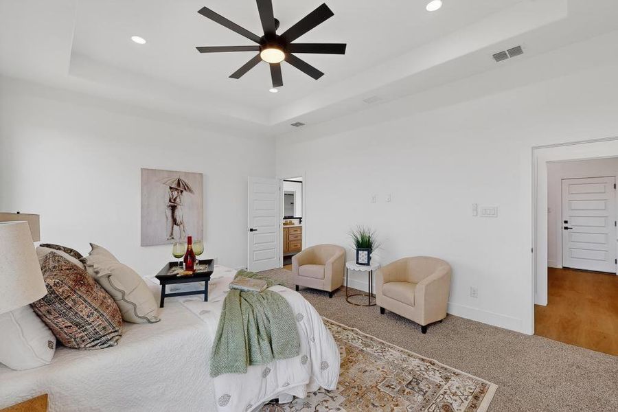 Bedroom featuring a raised ceiling, recessed lighting, carpet, and ceiling fan
