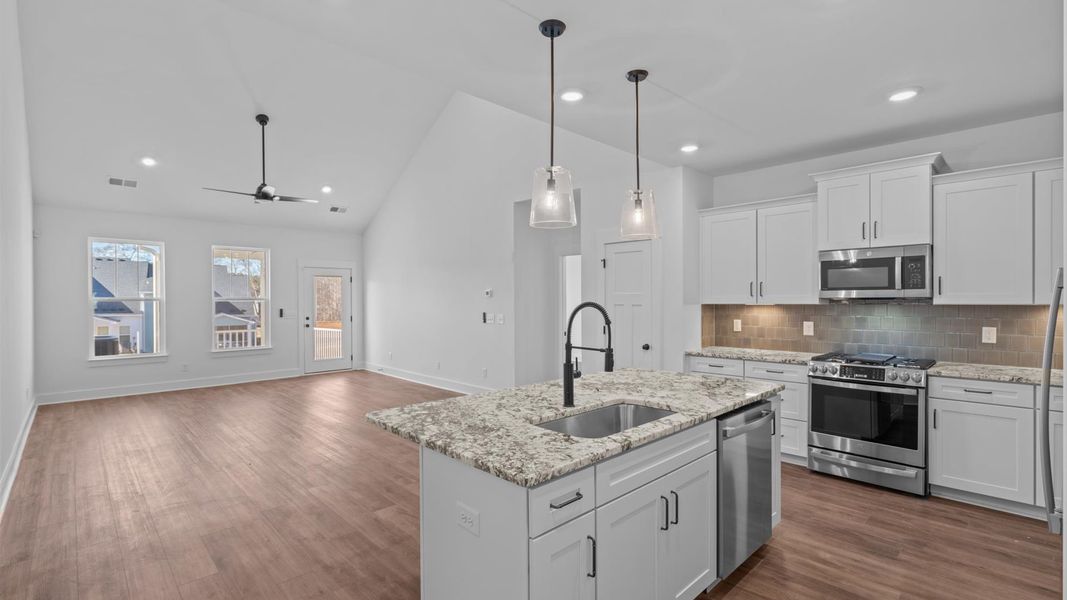 Elegant and compact island anchors this tasteful kitchen with high standards and timeless appeal