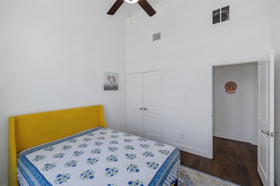 Bedroom featuring a closet, visible vents, ceiling fan, and wood finished floors