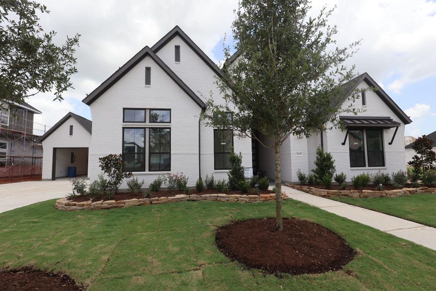 Front exterior of a new home in Dunham Pointe, Cypress, TX, highlighting curb appeal (Image 14). Front exterior of a new home in Dunham Pointe, Cypress, TX, highlighting curb appeal (Image 14).