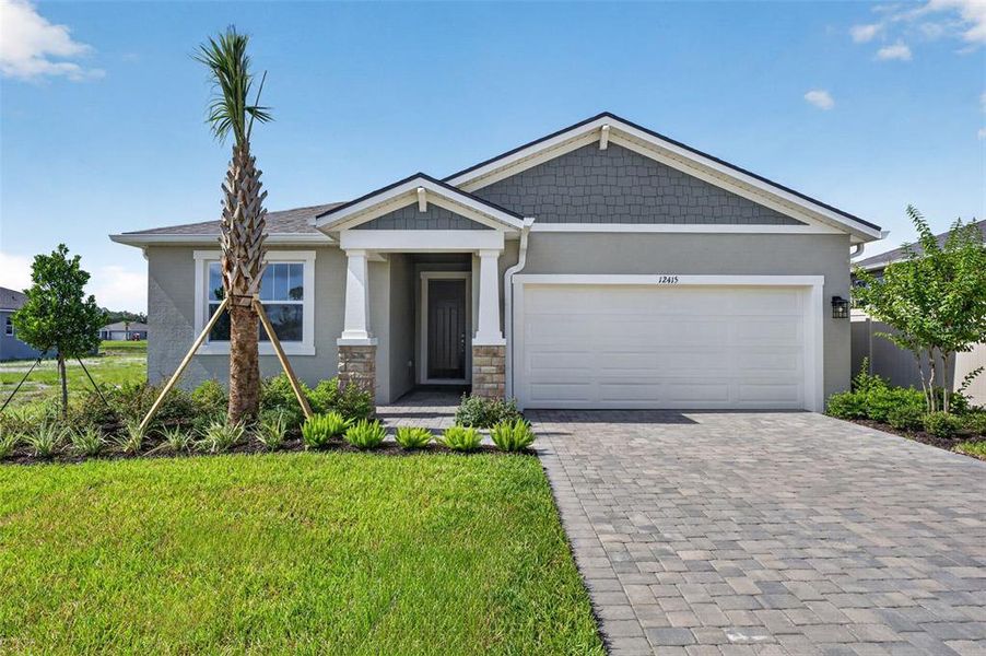 Front exterior of a new home in Windwater, Parrish, FL, highlighting curb appeal (Image 2). Front exterior of a new home in Windwater, Parrish, FL, highlighting curb appeal (Image 2).