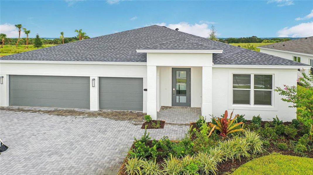 Front exterior of a new home in Cresswind at Lake Harris, Tavares, FL, highlighting curb appeal (Image 1).