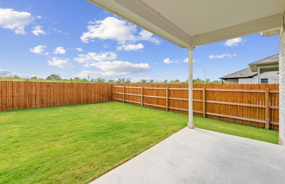 Fenced backyard featuring a patio area Fenced backyard featuring a patio area
