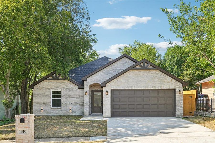 View of front of property featuring brick siding, an attached garage, and concrete driveway View of front of property featuring brick siding, an attached garage, and concrete driveway