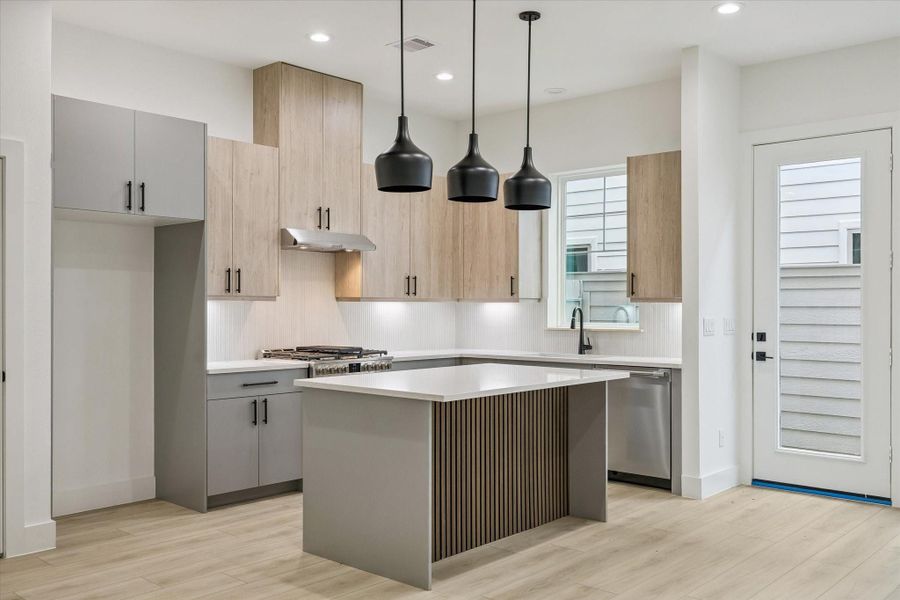 Chef-inspired kitchen with quartz countertops and warm wood cabinetry Chef-inspired kitchen with quartz countertops and warm wood cabinetry