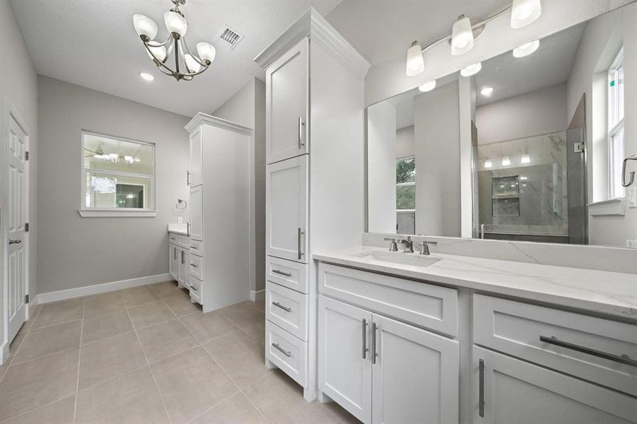 3 windows and a multitude of lights shine in this beautiful and functional Primary Bathroom.