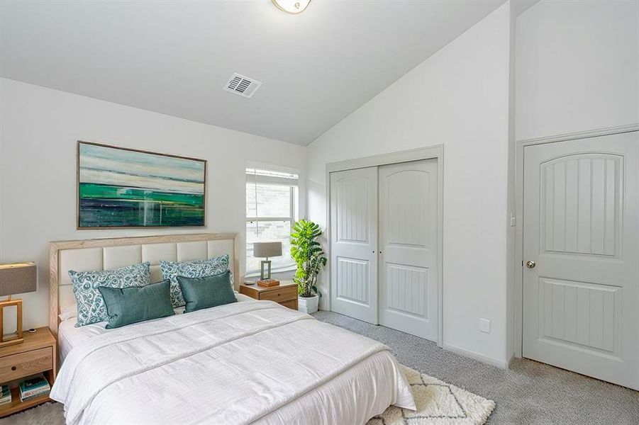 With vaulted ceilings and a neutral color scheme, this additional bedroom is both spacious and inviting. The plush carpeting adds warmth, while the double closet doors provide ample storage for all your needs. A bright window completes this room, making it a delightful space for relaxation or creativity.