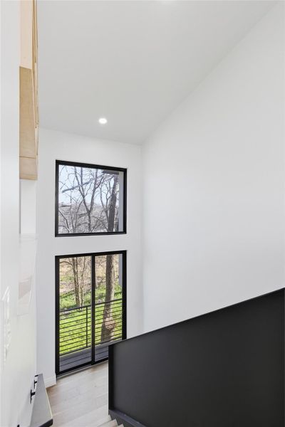 Stairway leading downstairs with a Juliet Balcony.